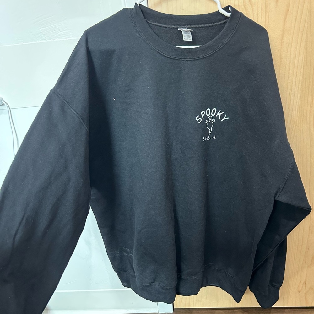 Sweatshirt with a ghost and “spooky season” on the chest